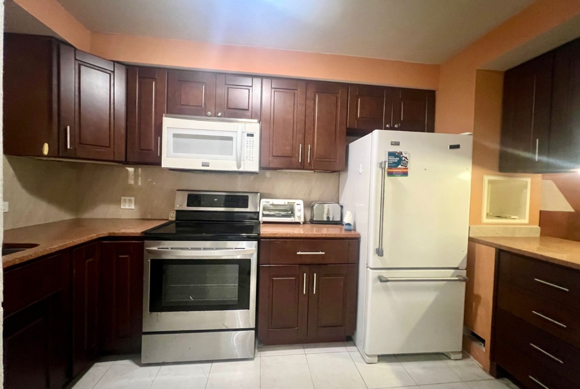 Furnished 2BR Condo for sale in Jolly Harbour, Antigua - TV Kitchen