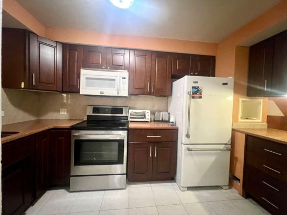 Furnished 2BR Condo for sale in Jolly Harbour, Antigua - TV Kitchen