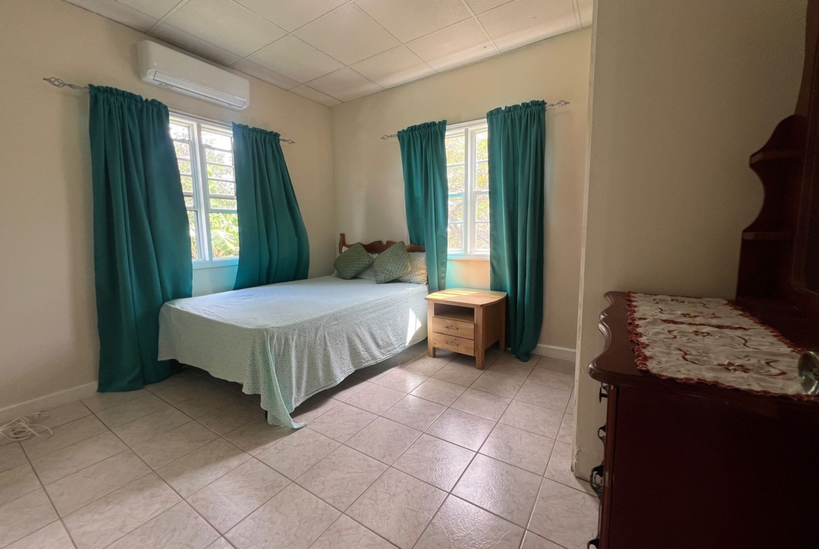 bedroom with natural light at Emerald Breeze Cottage.