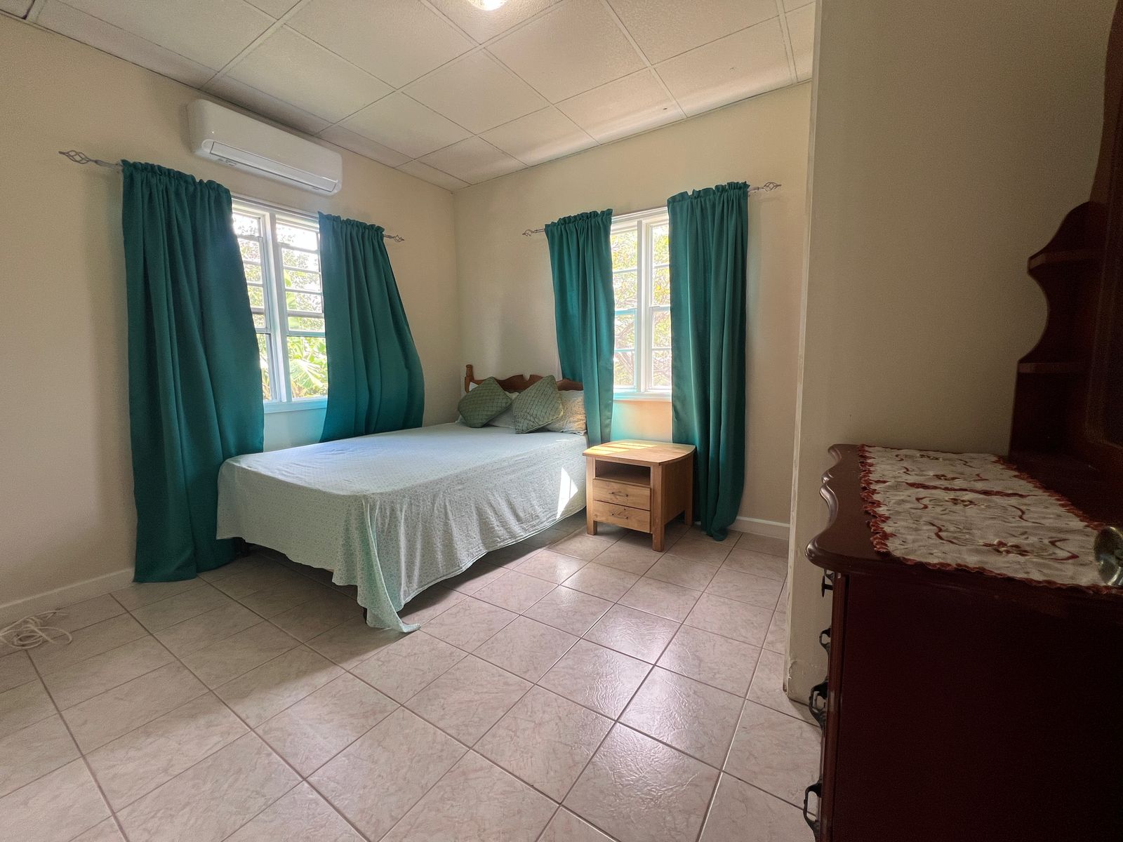 bedroom with natural light at Emerald Breeze Cottage.