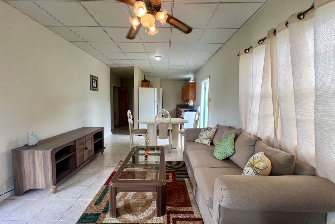 Open-concept living and dining area in Emerald Breeze Cottage.