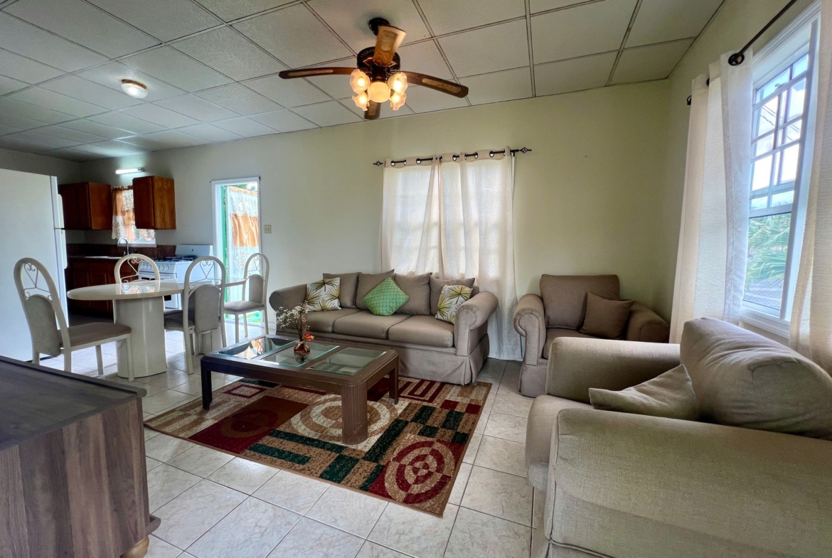 Elegant dining area with a view at Emerald Breeze Cottage.