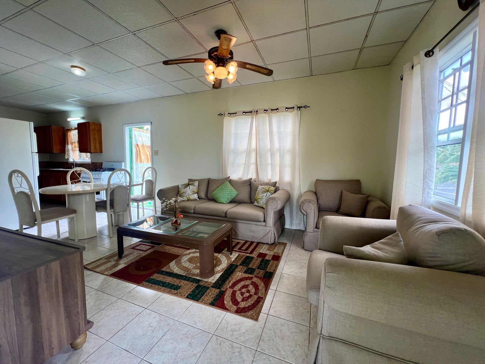 Elegant dining area with a view at Emerald Breeze Cottage.