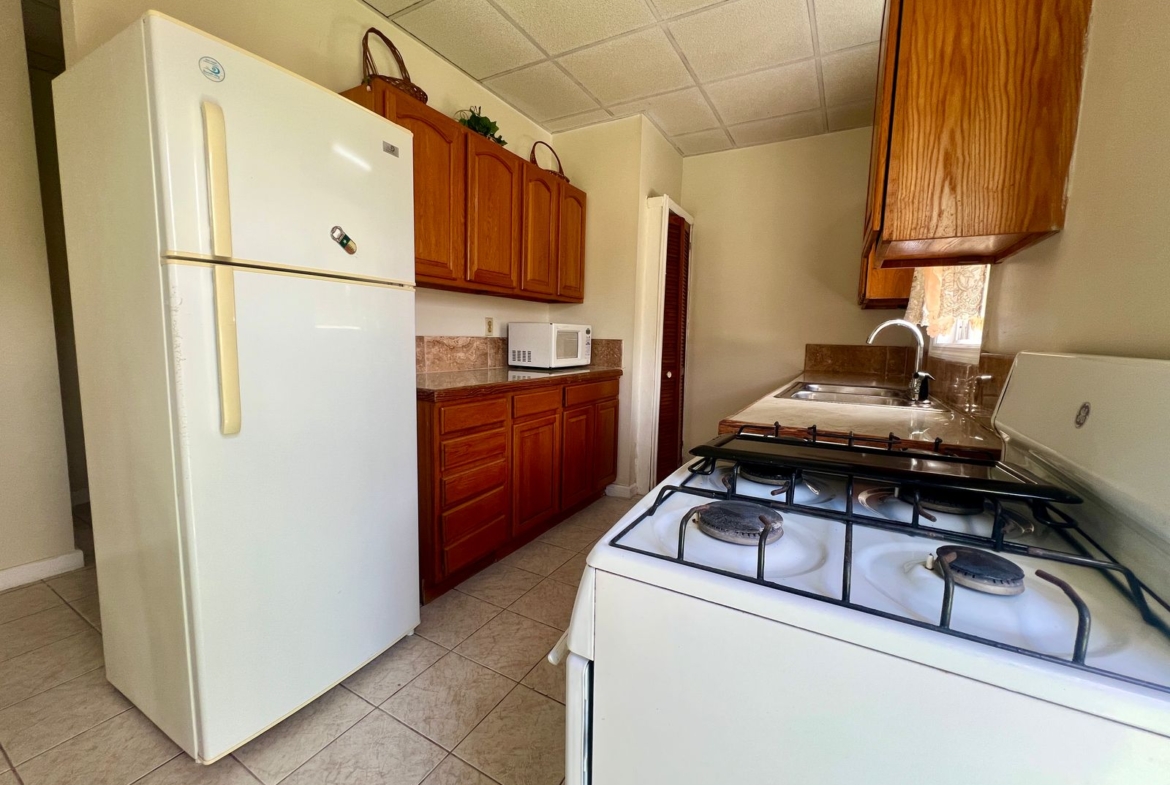 Fully equipped kitchen with sleek design in Emerald Breeze Cottage.