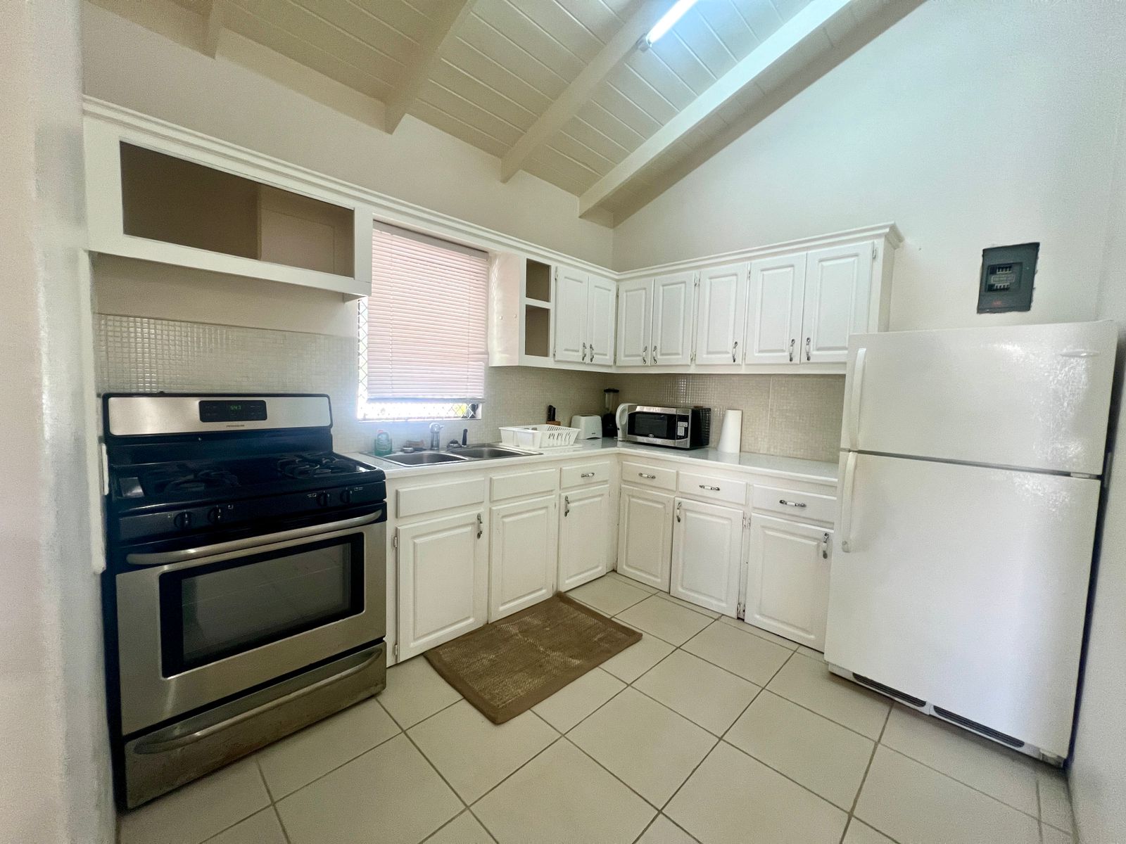 Modern kitchen with appliances in rental unit