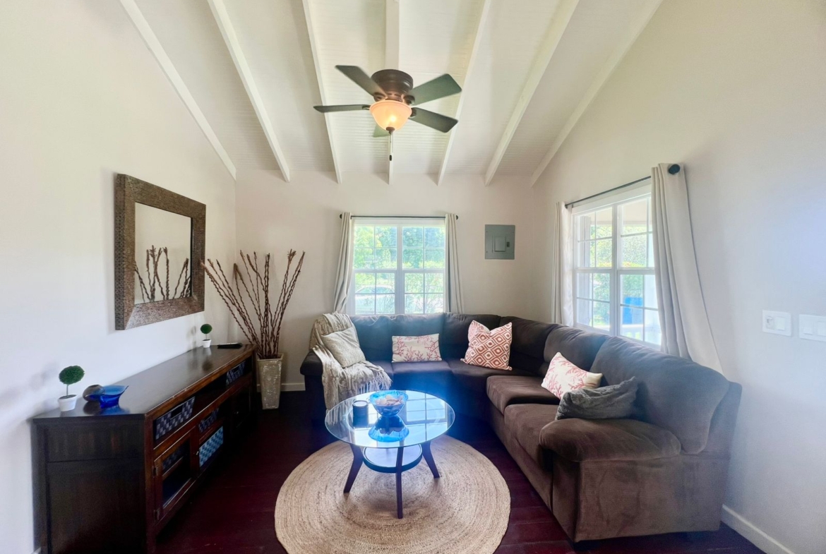 Living room with flat-screen TV and inverter A/C in Royal Gardens cottage, Antigua